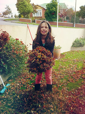 happy child throwing leaves