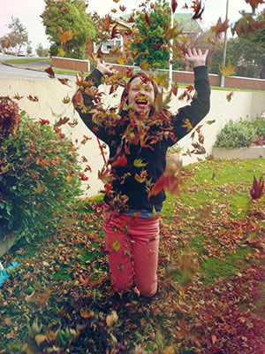 happy child throwing leaves