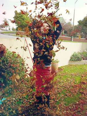 happy child throwing leaves
